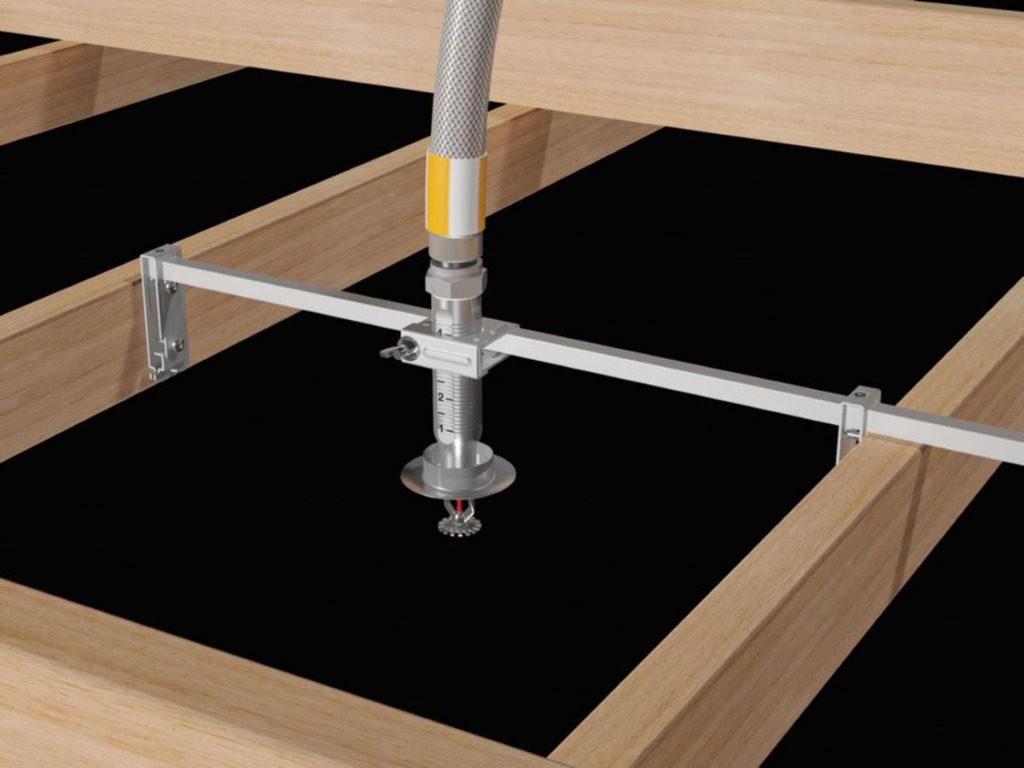 Flex drop braided stainless hose connecting sprinkler pipe to concealed head in ceiling framing